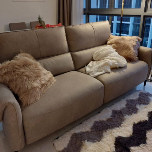 Modern taupe sofa with decorative pillows and throw.